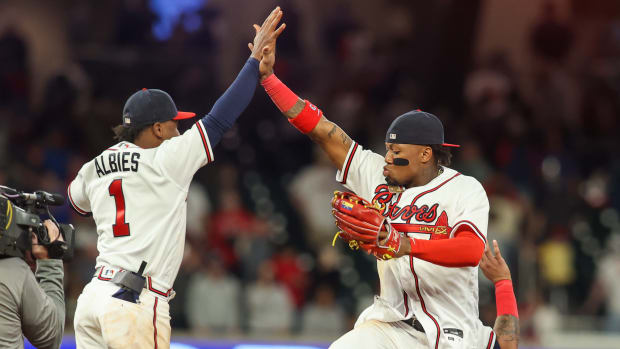 Apr 11, 2023; Atlanta, Georgia, USA; Atlanta Braves second baseman Ozzie Albies (1) and right fielder Ronald Acuna Jr. (13) celebrate a victory against the Cincinnati Reds at Truist Park.